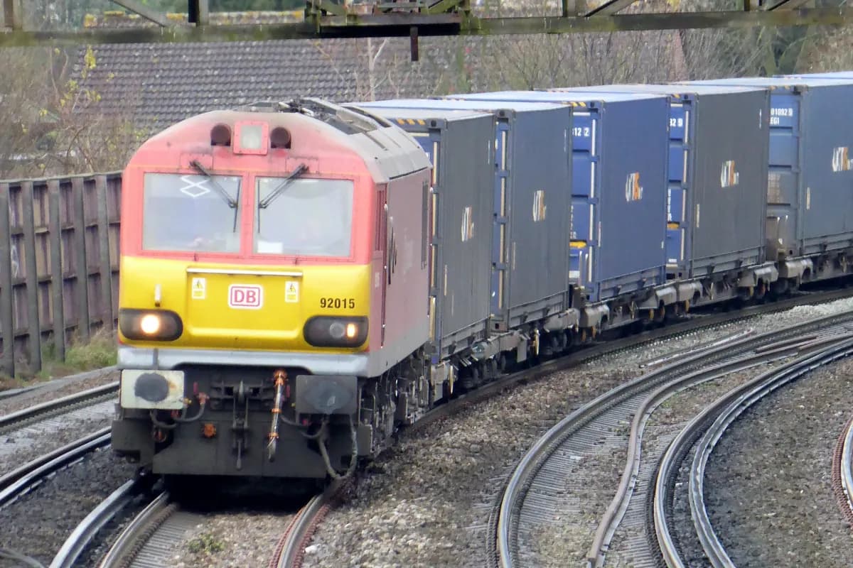 Electric locomotive hauling intermodal shipping containers on rail